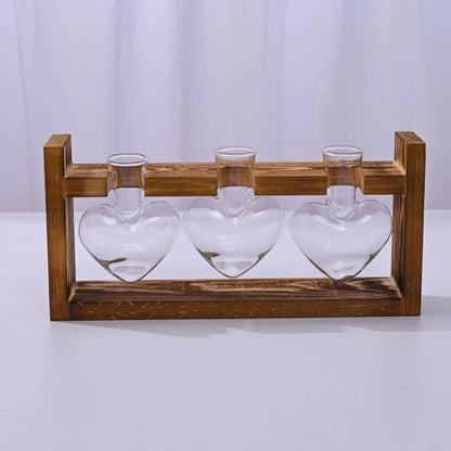 Nutshell tabletop glass planter propagation station with three heart-shaped vases on a wood base