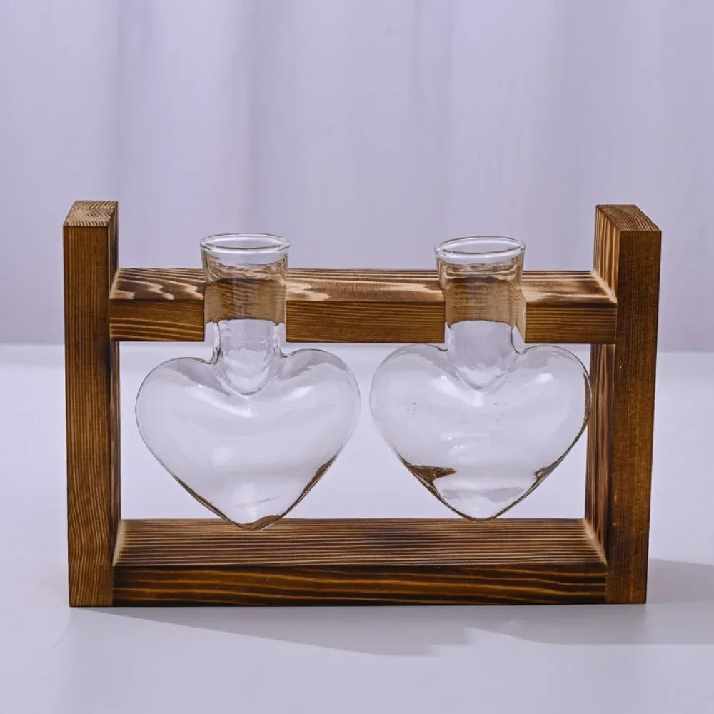 Nutshell tabletop glass planter propagation station with two heart-shaped glass vases on a wooden stand