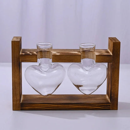 Nutshell tabletop glass planter propagation station with two heart-shaped glass vases on a wooden stand