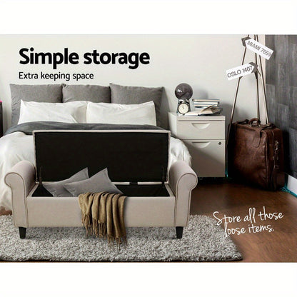 Taupe storage ottoman bench with a spacious interior for organizing loose items in a modern bedroom