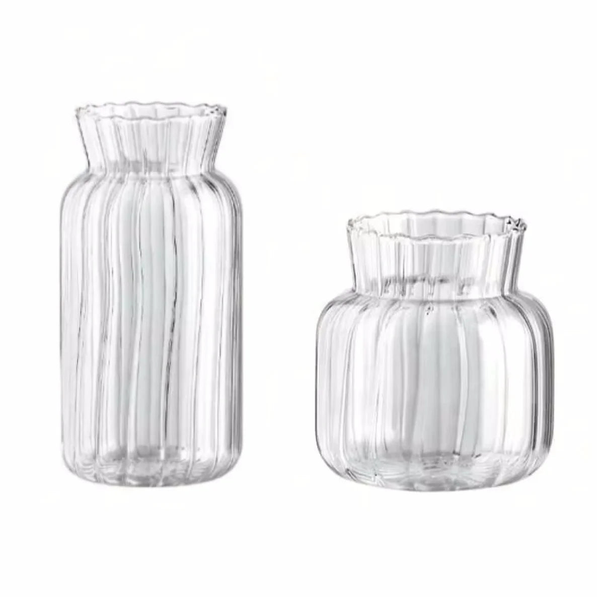Set of two transparent glass vases for flowers featuring a ribbed design and fluted edges