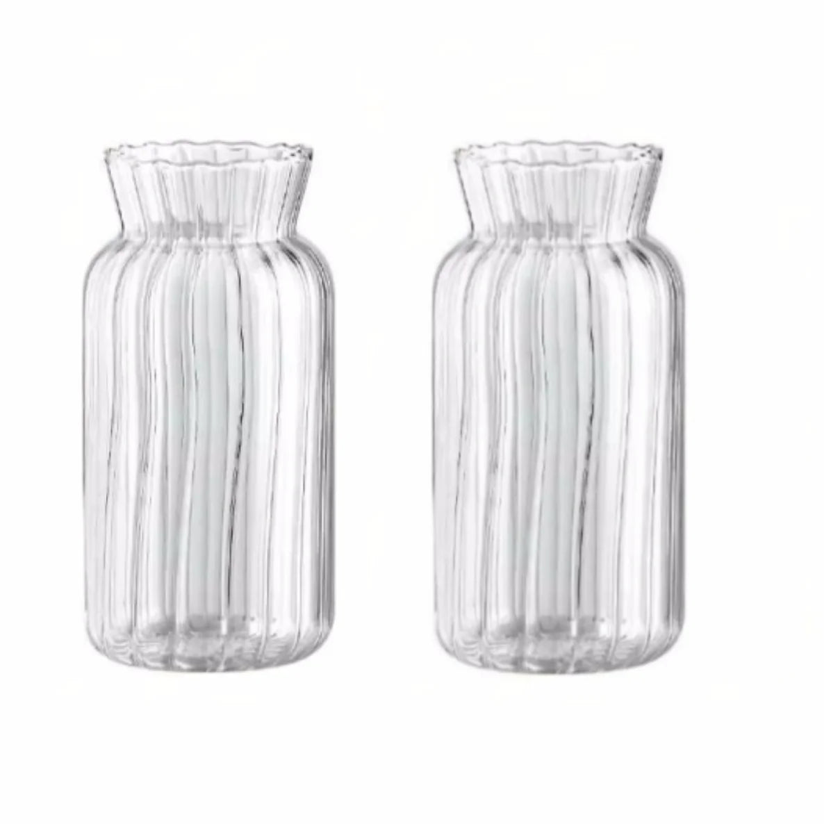 Set of two textured transparent glass vases for flowers with a wavy top design
