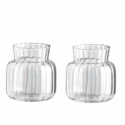 Set of two transparent glass vases for flowers with ribbed design and fluted edges