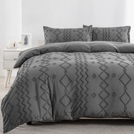 Nutshell tufted gray duvet cover set with geometric embroidered patterns on bed with matching pillows