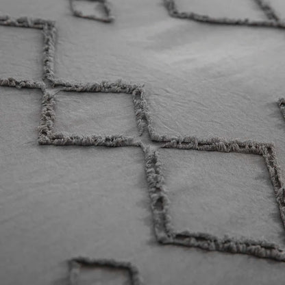 Close-up of Nutshell tufted gray duvet cover set with textured diamond pattern and soft fabric