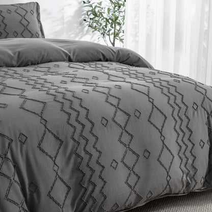 Nutshell tufted gray duvet cover set with geometric patterns on a bed by a bright window