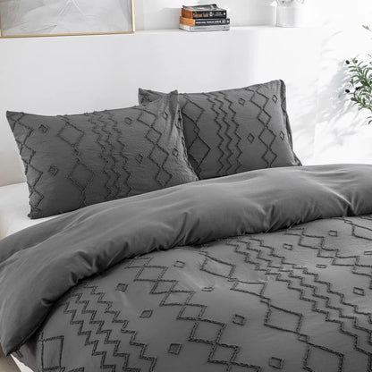 Nutshell tufted gray duvet cover set with textured geometric pattern on bed with matching pillow shams