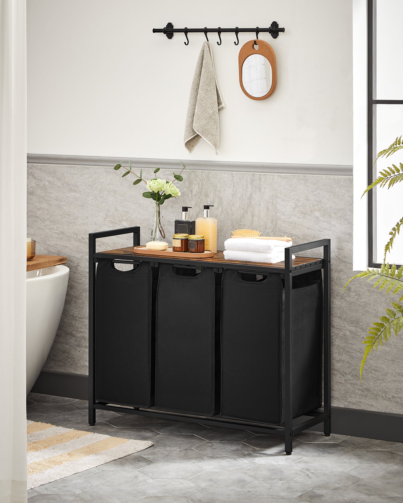 Nutshell laundry hamper with removable bags featuring three compartments for efficient sorting
