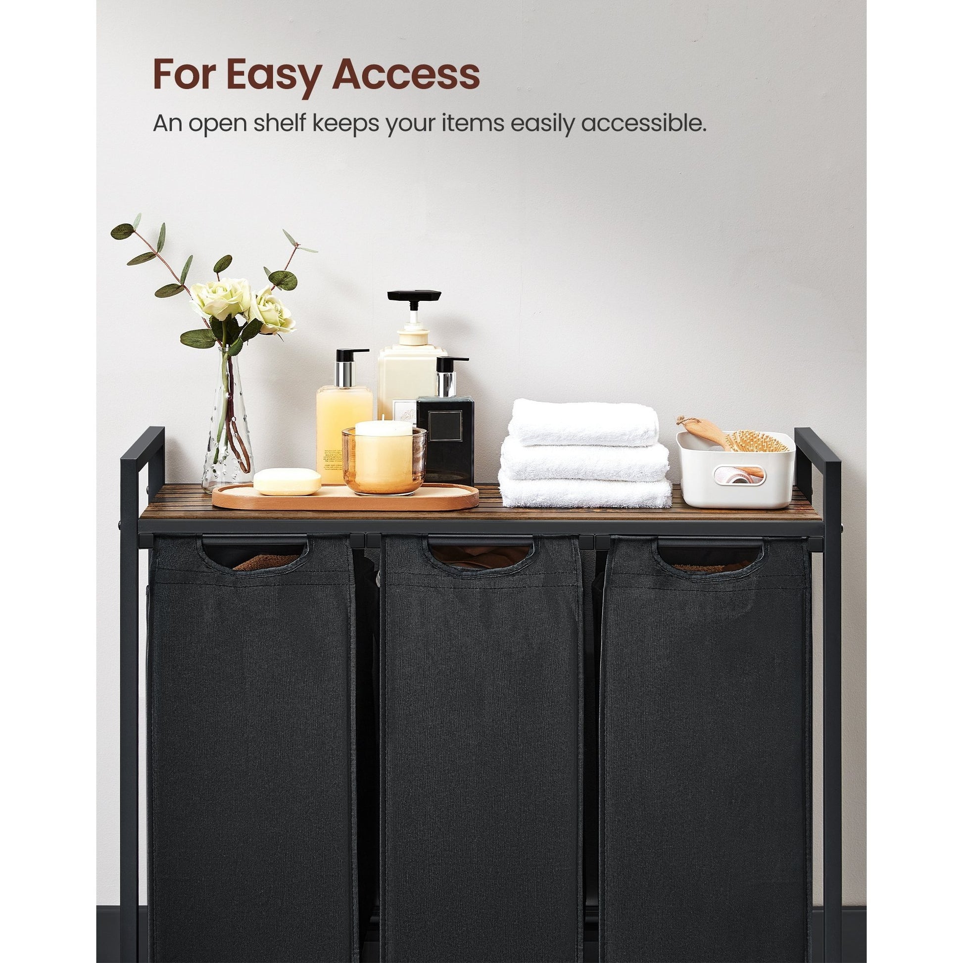 Nutshell laundry hamper with removable bags featuring an open shelf for easy access to items