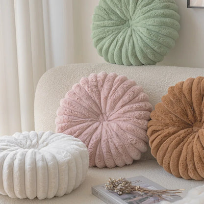 Nutshell round pumpkin pillow cushions in white pink brown and green on beige sofa