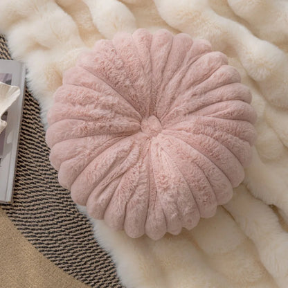 Nutshell soft pink round pumpkin pillow cushion with plush texture on cozy blankets