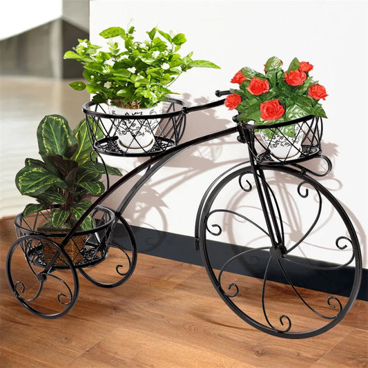 Nutshell rustic iron flower stand shaped like a vintage bicycle holding three potted plants indoors