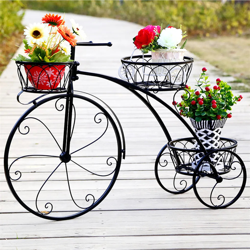 Nutshell rustic iron flower stand shaped like a vintage bicycle with three baskets holding colorful flowers