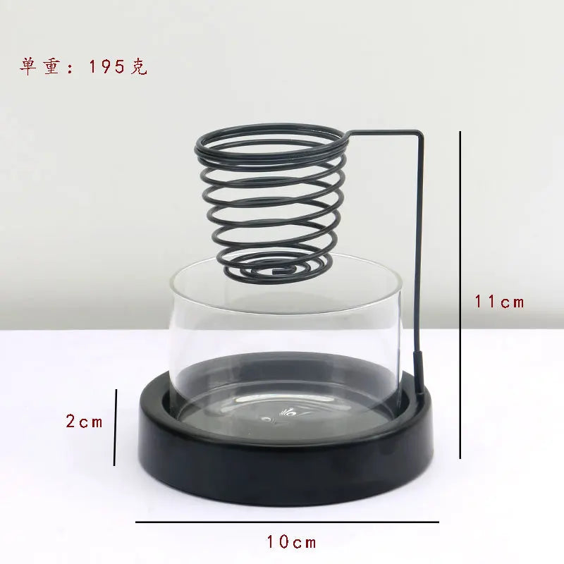 Nutshell sage incense burner with black metal spring holder and glass base measuring 10cm diameter