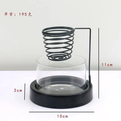 Nutshell sage incense burner with black metal spring holder and glass base measuring 10cm diameter