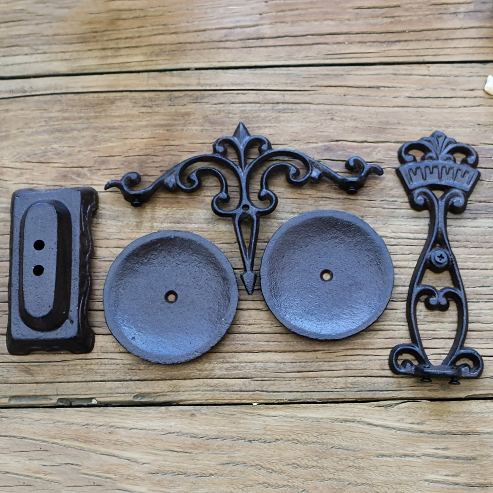 Vintage cast iron candle holder pieces including ornate base and two candle cups