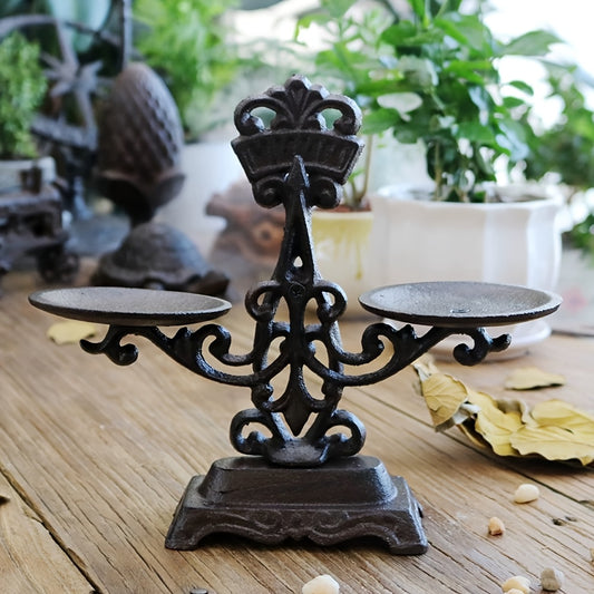 Vintage cast iron candle holder with intricate design and two candle plates for elegant decor