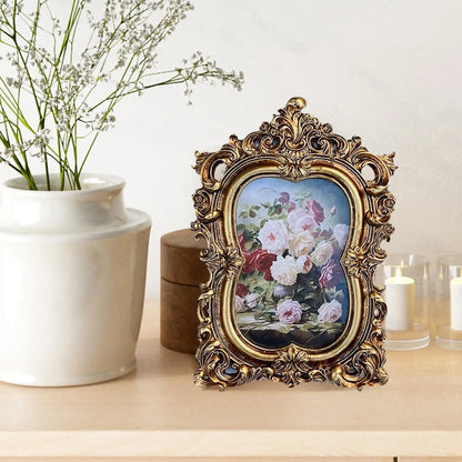 Vintage gold resin photo frame showcasing a floral print with elegant ornate details