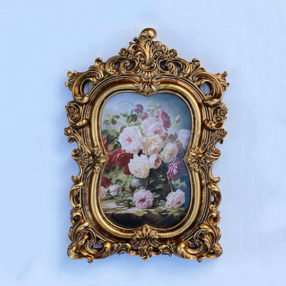 Vintage gold resin photo frame with ornate detailing, showcasing a floral artwork inside