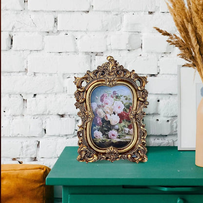 Vintage gold resin photo frame with ornate design showcasing beautiful floral artwork