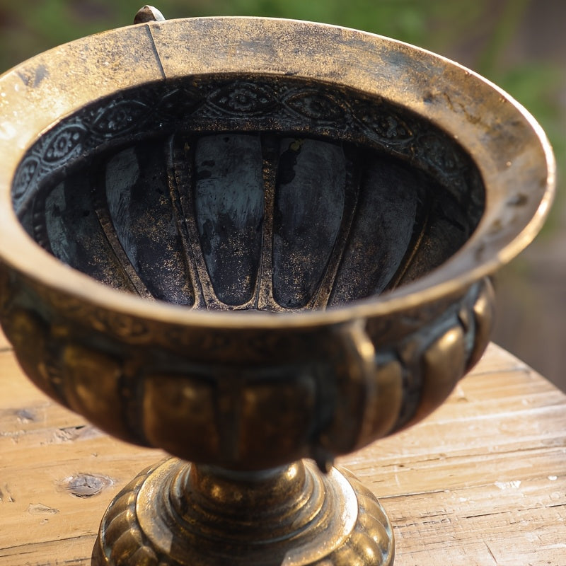Nutshell vintage wrought iron pot with detailed ornate design on wooden surface