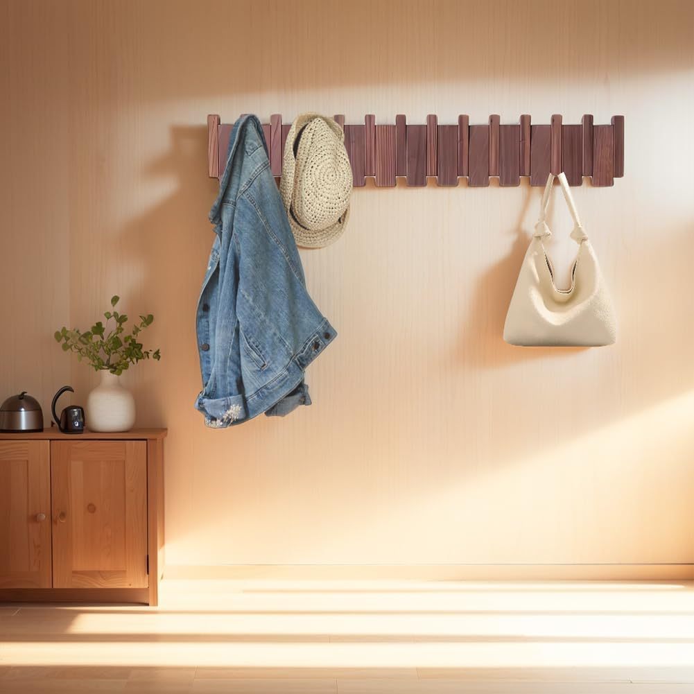 Nutshell wall mounted wooden coat hook showcasing a denim jacket, hats, and bags in a cozy living space