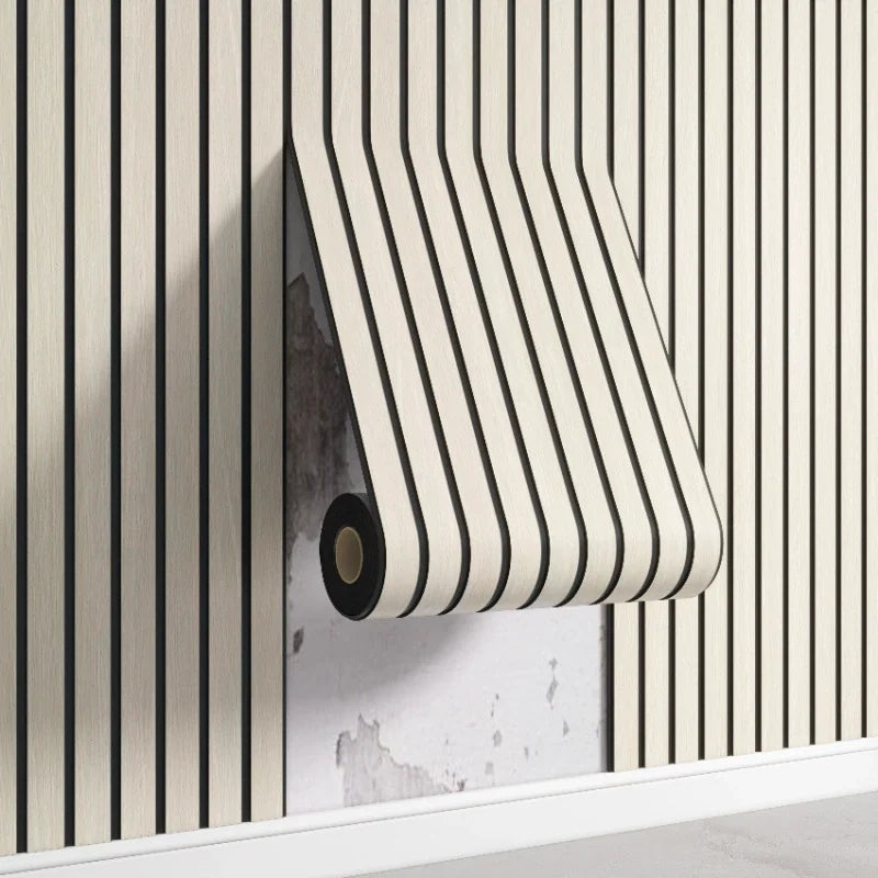 Nutshell woodgrain wallpaper roll with thin black vertical stripes peeling off wall to reveal damaged plaster