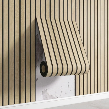 Nutshell woodgrain wallpaper roll with vertical black slats being applied over damaged plaster wall