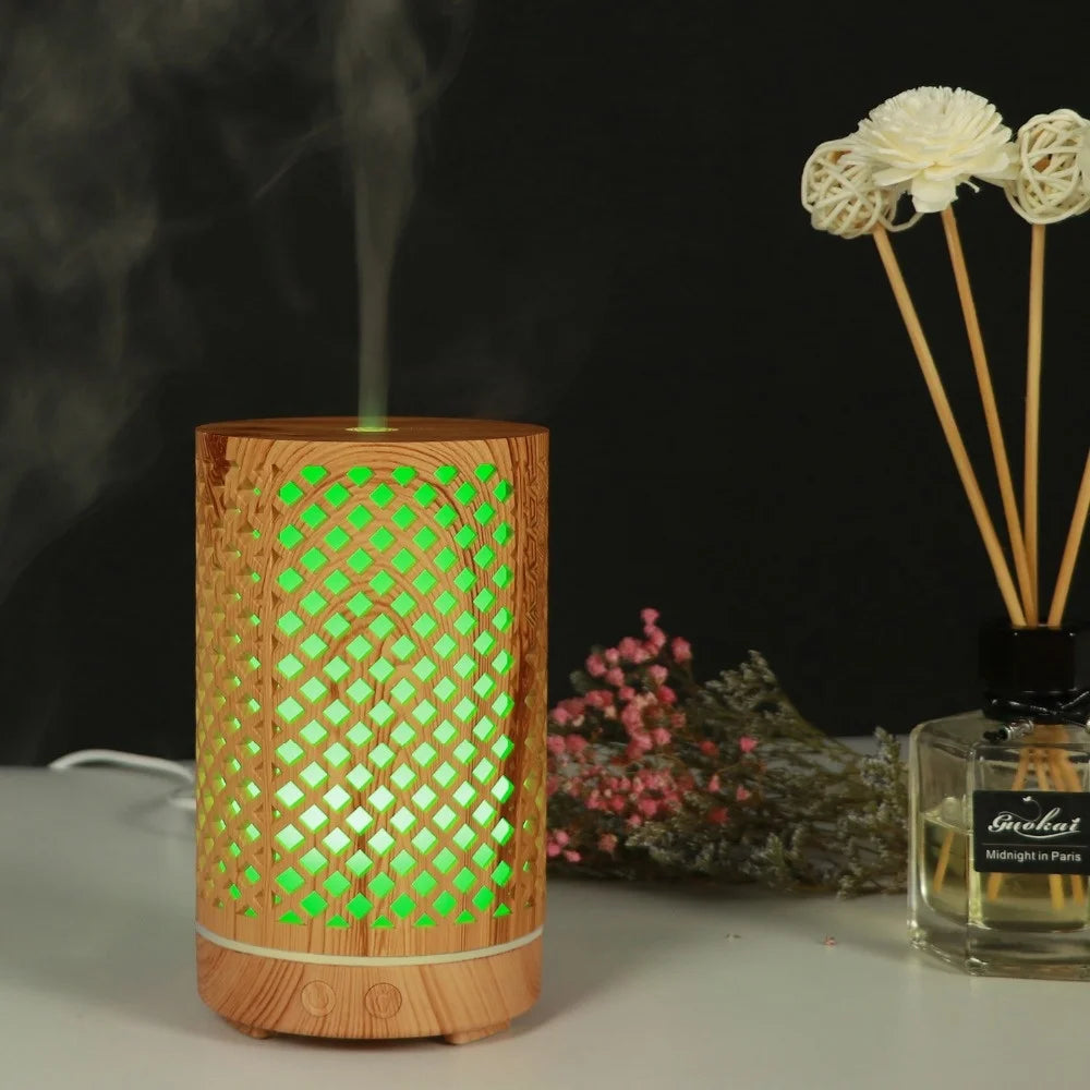 Nutshell wood grain essential oil diffuser with green light and mist on a white surface