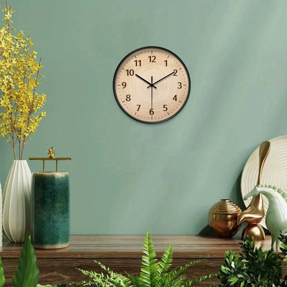 Nutshell wood grain wall clock on green wall with modern decor and plants
