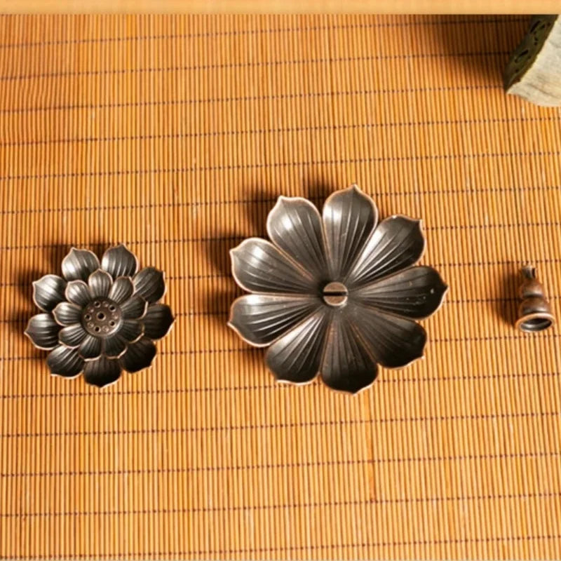 Nutshell Zen lotus incense burner metal holder with flower-shaped parts on bamboo mat