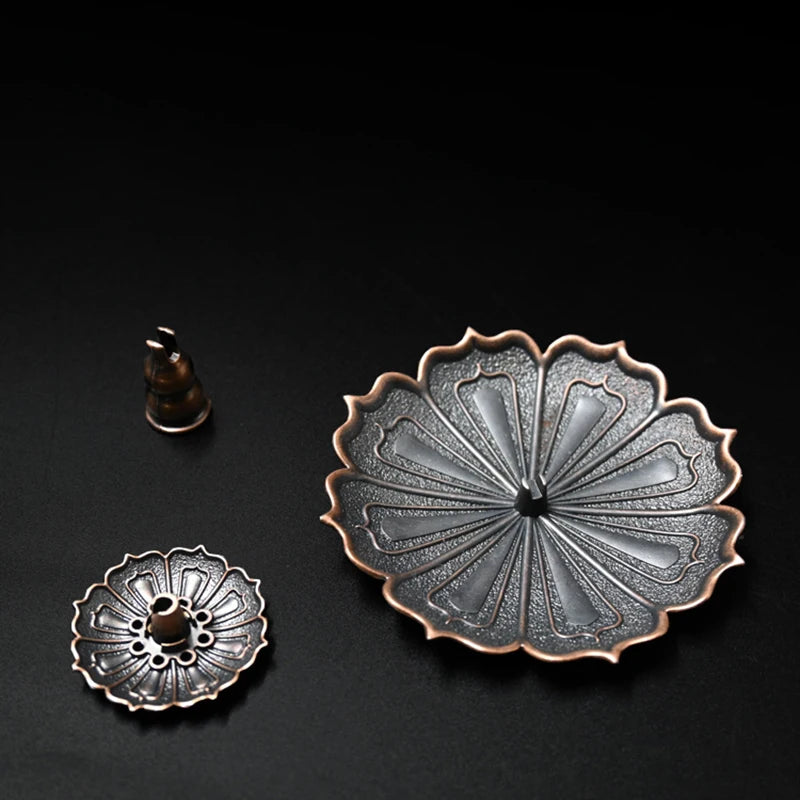 Nutshell Zen lotus incense burner metal holder with detailed petal design on black background