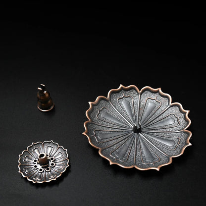 Nutshell Zen lotus incense burner metal holder with detailed petal design on black background