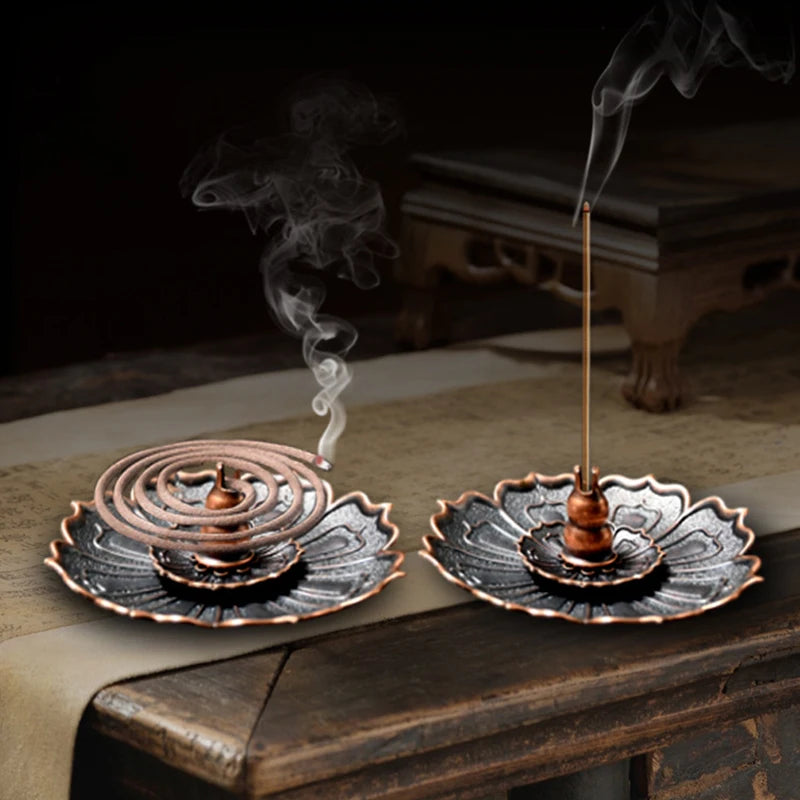 Nutshell Zen lotus incense burner metal holder with spiral and stick incense on wooden table