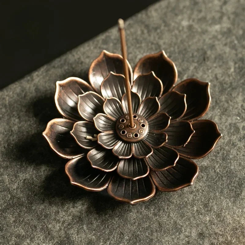 Nutshell Zen lotus incense burner in bronze with detailed petals and central holder for incense stick