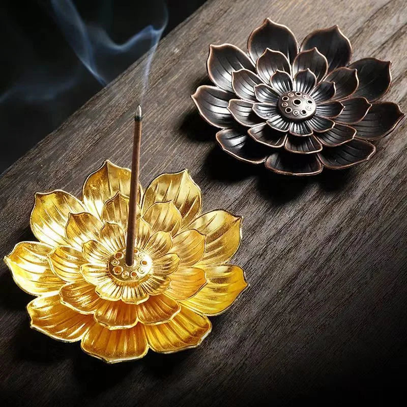 Nutshell Zen lotus incense burner in gold and bronze lotus flower designs holding burning incense sticks
