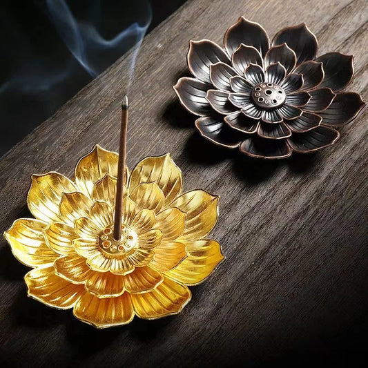 Nutshell Zen lotus incense burner in gold and bronze lotus flower designs holding burning incense sticks