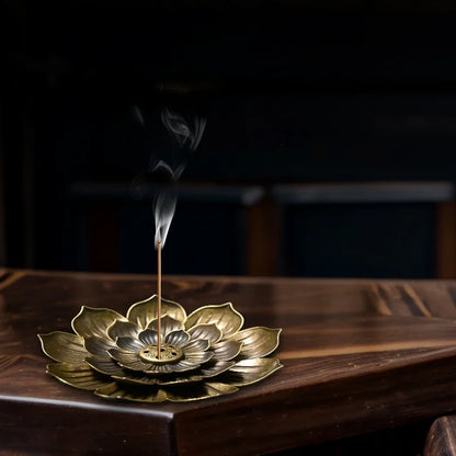Zen lotus incense burner by Nutshell in brass with detailed lotus petals holding a burning incense stick