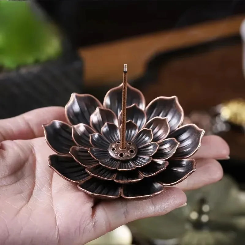 Nutshell Zen lotus incense burner metal holder with detailed petals held in hand