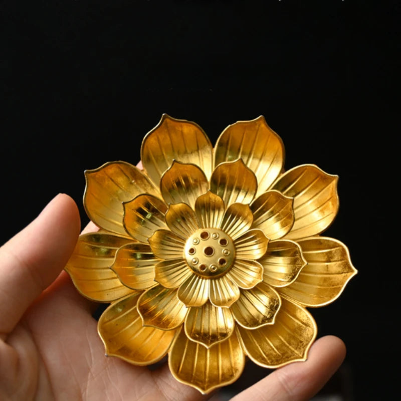 Nutshell zen lotus incense burner in gold held in hand designed as a detailed flower-shaped incense holder